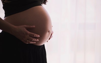 pregnant woman holding stomach