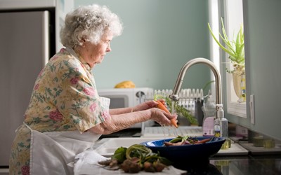 older woman cooking at home