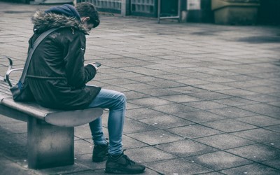 young man sitting on bench