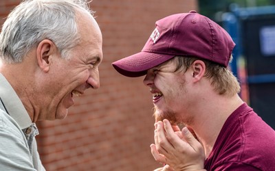 Older and younger man laughing together