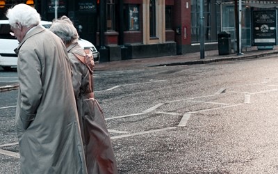 Two older people walking 